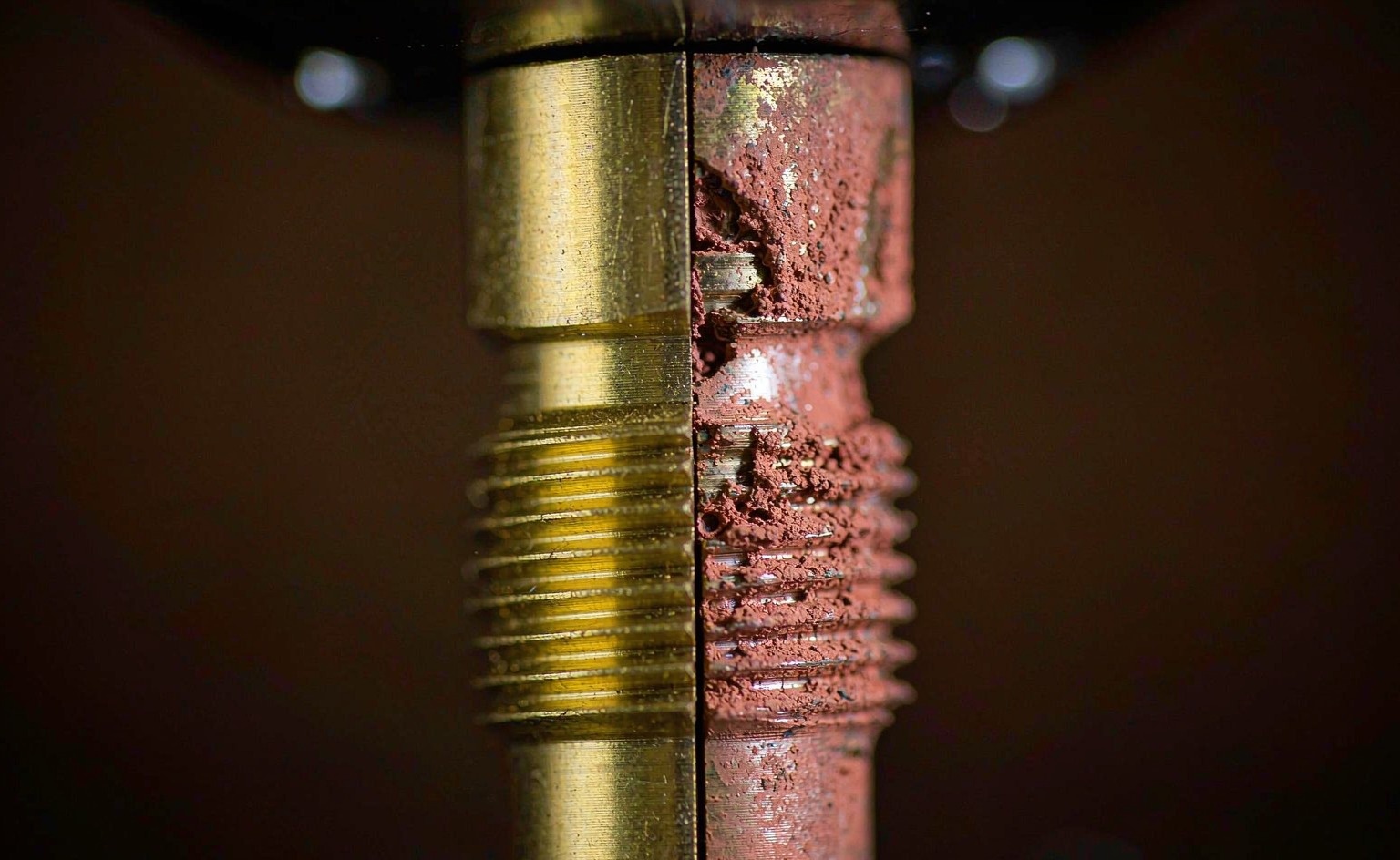 Brass wetted part before and after dezincification: sound golden brass on the left, porous reddish copper on the right